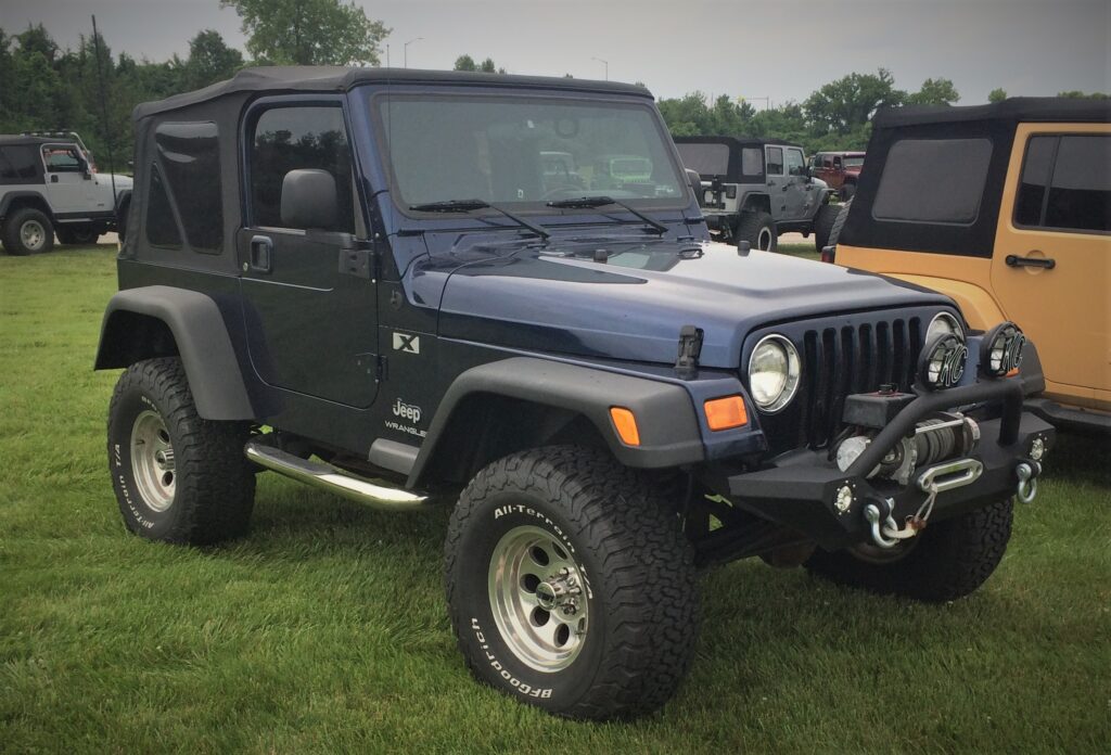 blue-jeep-tj-wrangler-1024x696-1 a blue jeep wrangler tj parked on grass