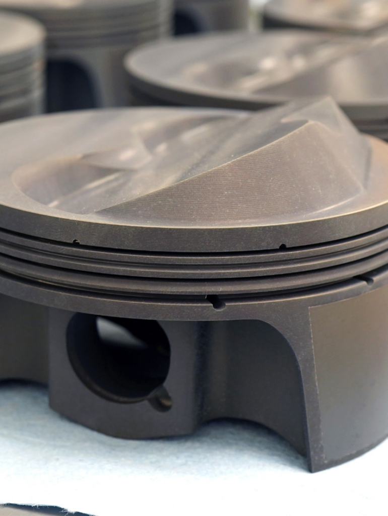 close-up-of-valve-reliefs-on-a-piston-head-770x1024-1 close up of valve reliefs on a piston head